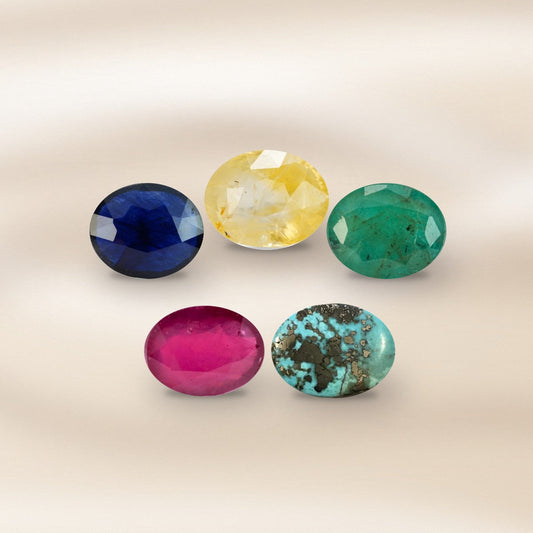 Five loose gemstones on silk