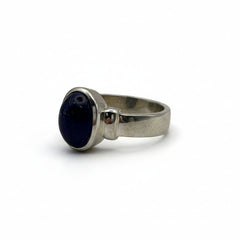 Silver ring with a lapiz lazuli gemstone on a gray background